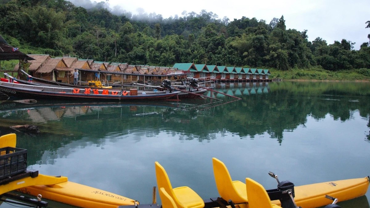 Khao Sok floating bungalows and longtail boats on jungle lake